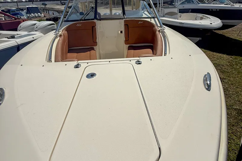 Slide: The Image of 2018 Scout 275 Dorado boat with tan seating, docked outdoors. - 12