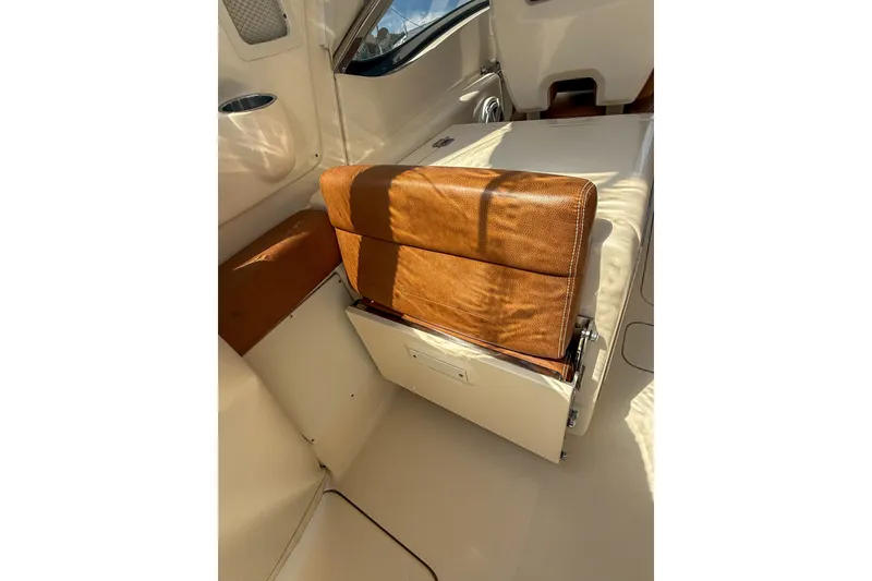 Slide: The Image of 2018 Scout 275 Dorado boat interior with tan leather seating and white accents. - 19