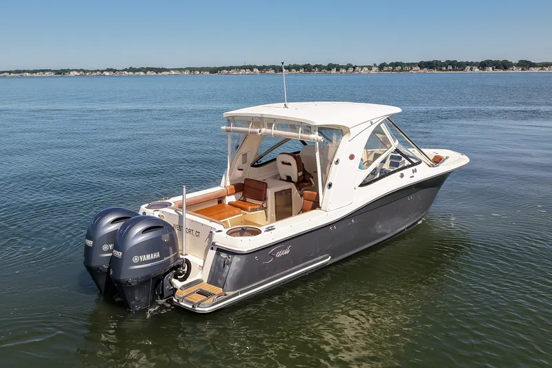 Slide: The Image of 2018 Scout 275 Dorado boat with twin Yamaha engines on calm water. - 7