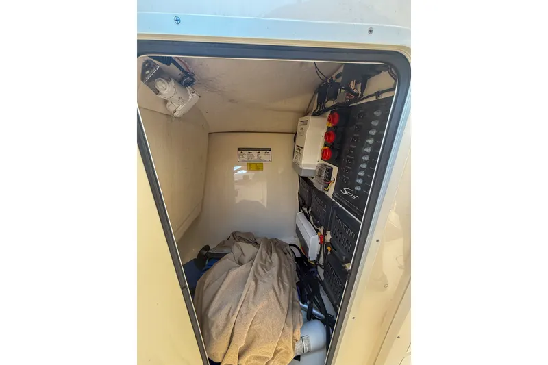 Slide: The Image of Electrical panel inside 2018 Scout 275 Dorado boat, featuring wiring and equipment. - 30