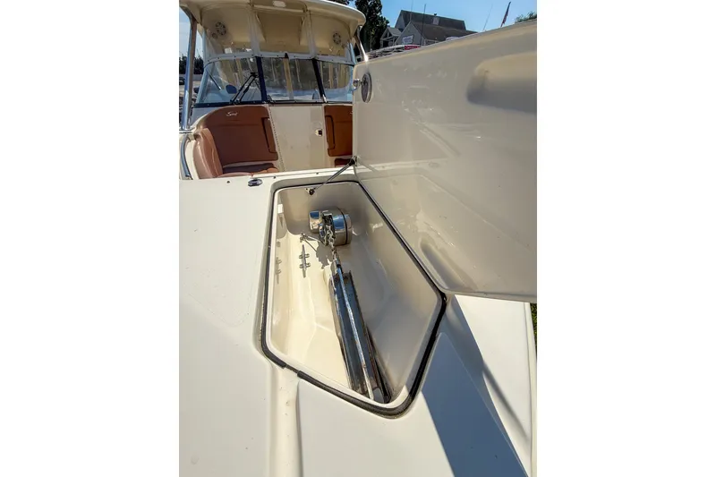 Slide: The Image of 2018 Scout 275 Dorado boat anchor compartment with open hatch, showcasing interior details. - 13