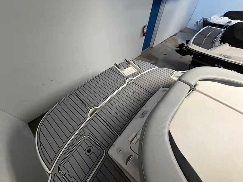 Slide: The Image of The image shows the stern of a 2015 Starcraft 220 STARSTEP boat with a gray deck. - 17