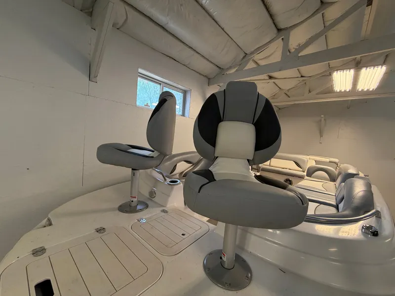Slide: The Image of Two swivel seats on a boat, surrounded by cushioned seating areas, in an enclosed space. - 8