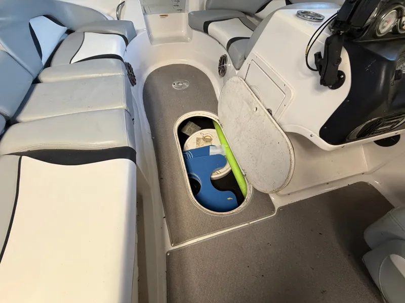 Slide: The Image of The image shows the interior of a 2015 Starcraft 220 STARSTEP boat. There are seats and a storage compartment. - 23