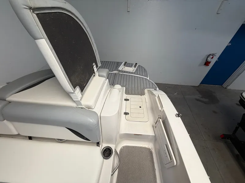 Slide: The Image of The image shows the stern of a 2015 Starcraft 220 STARSTEP boat with seating and storage. - 36