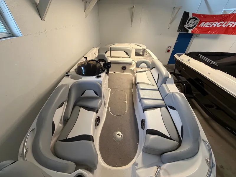 Slide: The Image of The image shows the interior of a 2015 Starcraft 220 STARSTEP boat with gray and white seating. - 30