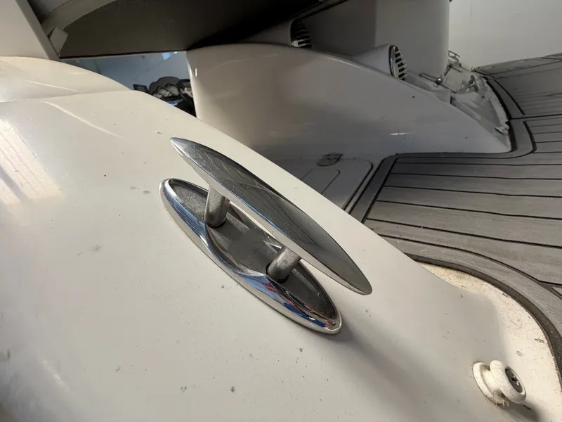 Slide: The Image of Close-up of a boat deck with silver cleat fitting and gray flooring. - 9