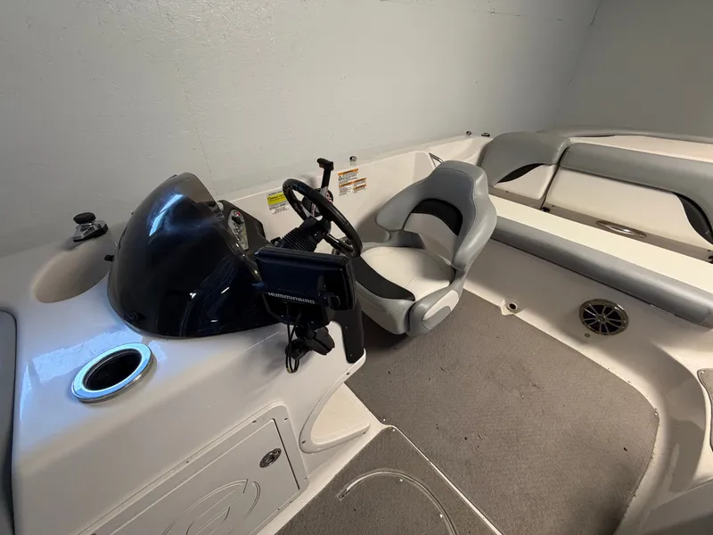 Slide: The Image of The image shows the cockpit of a 2015 Starcraft 220 STARSTEP with a helm and seating. - 33