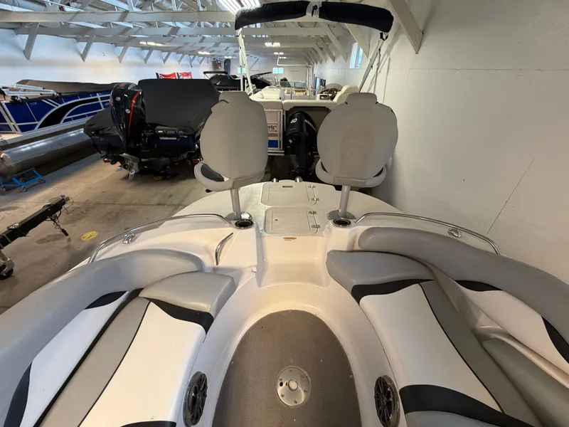 Slide: The Image of The image shows the interior of a 2015 Starcraft 220 STARSTEP boat in a storage facility. - 27