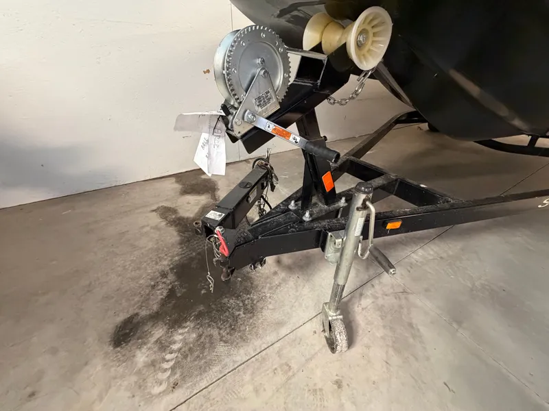 Slide: The Image of A boat trailer with a winch and a support wheel on a concrete floor. - 43