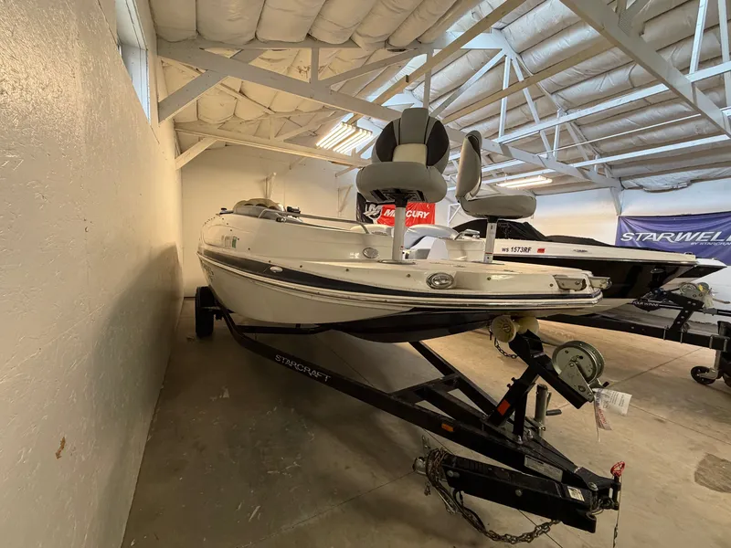 Slide: The Image of A 2015 Starcraft 220 STARSTEP boat on a trailer in a storage facility. - 3