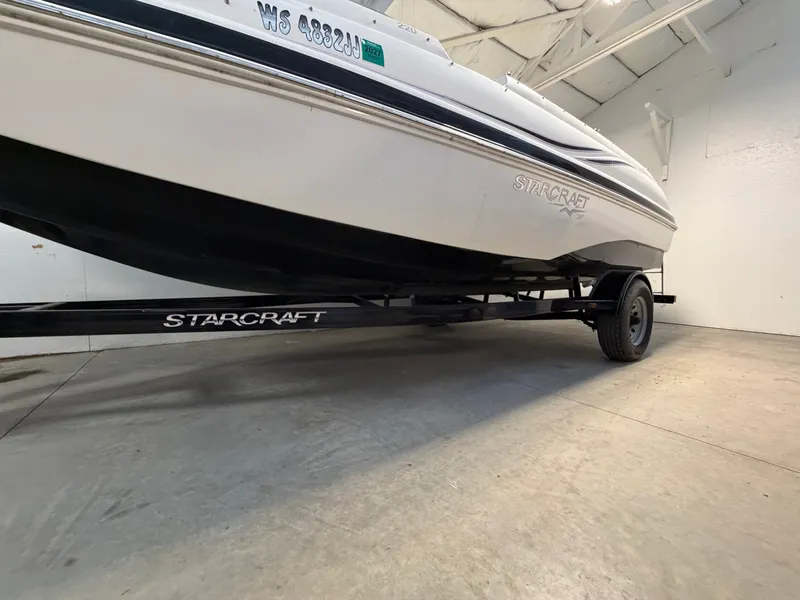 Slide: The Image of A 2015 Starcraft 220 STARSTEP boat on a trailer inside a warehouse. - 4