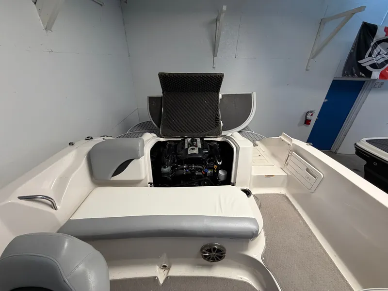 Slide: The Image of Interior of a 2015 Starcraft 220 STARSTEP boat with seating and engine cover. - 20