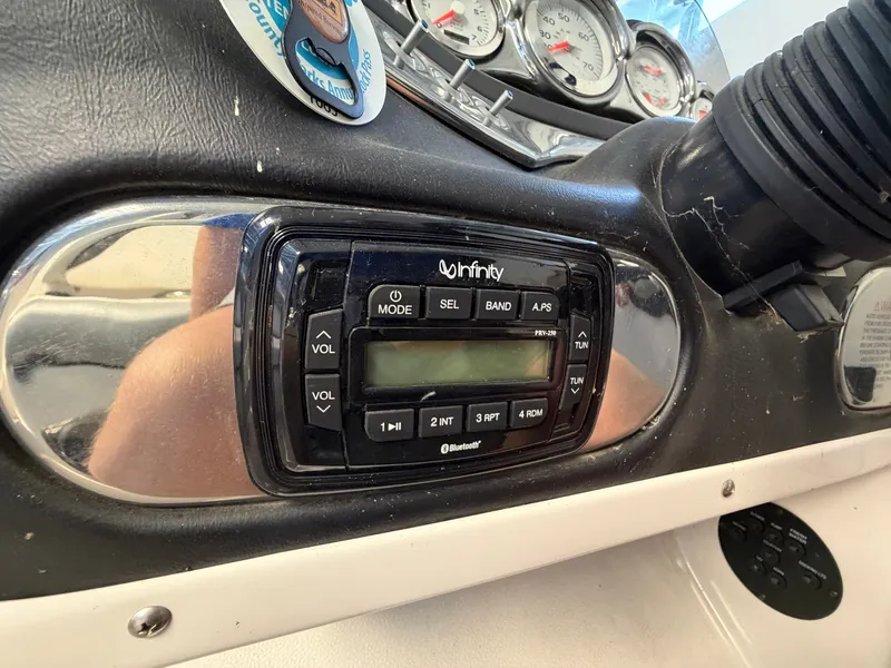 Slide: The Image of Close-up of a boat dashboard featuring an Infinity audio system and several gauges. - 38
