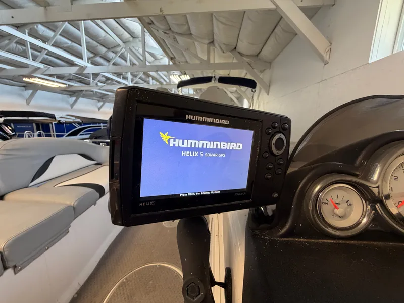 Slide: The Image of A Humminbird HELIX 5 sonar GPS is mounted on a boat. Seats are visible in the background. - 41