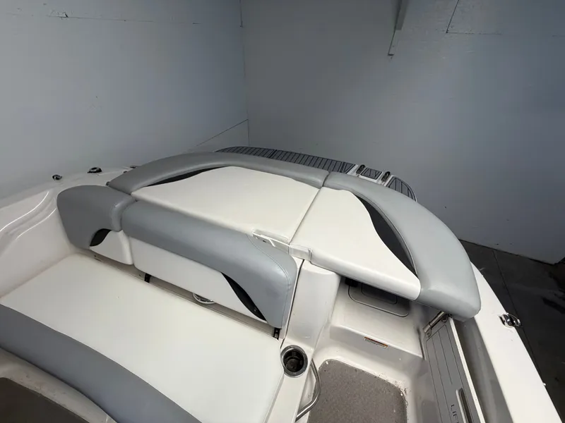 Slide: The Image of The image shows the stern of a 2015 Starcraft 220 STARSTEP boat with gray and white upholstery. - 37