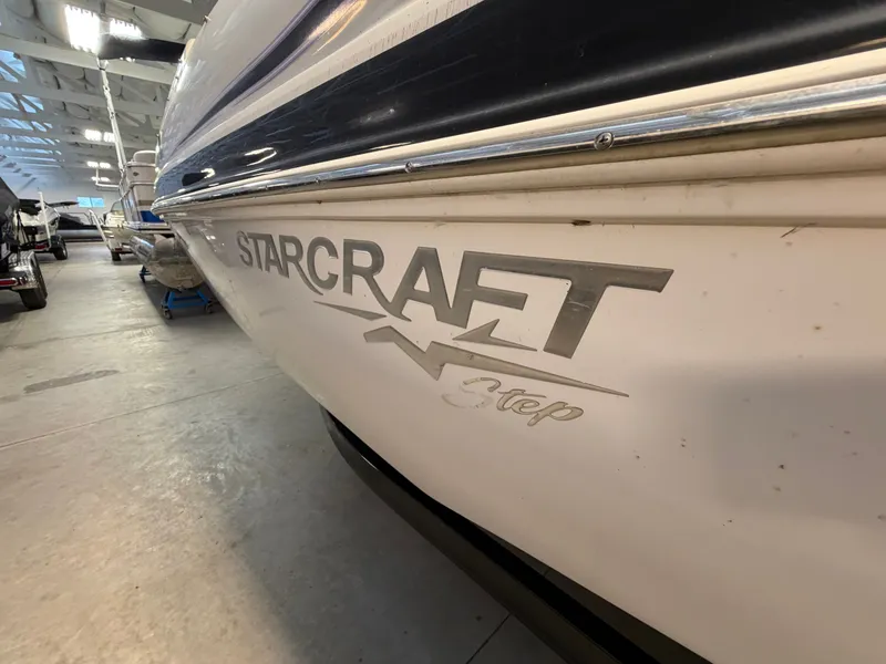 Slide: The Image of Close-up of a Starcraft 220 STARSTEP boat hull in a storage facility. - 6
