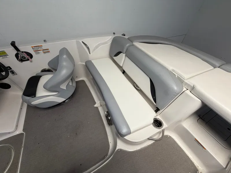 Slide: The Image of Interior of a 2015 Starcraft 220 STARSTEP with gray and white seating. - 35