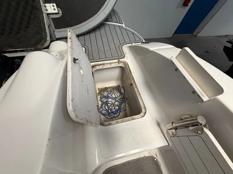 Slide: The Image of An open storage compartment on a boat with a rope inside. - 18