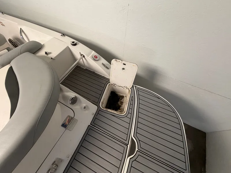 Slide: The Image of The image shows the deck of a 2015 Starcraft 220 STARSTEP with an open hatch. - 14