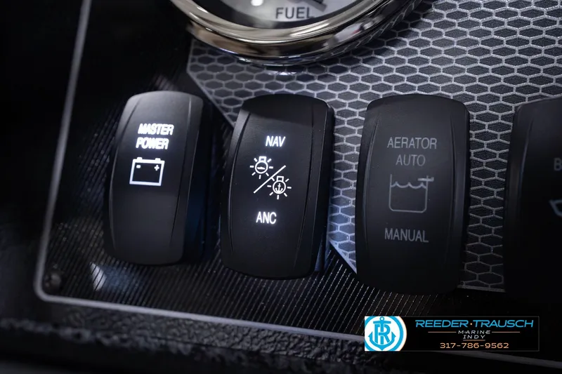 Slide: The Image of Dashboard controls of 2026 Lund 1800 Explorer SS boat, featuring power and navigation switches. - 40