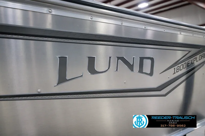 Slide: The Image of 2026 Lund 1800 Explorer SS boat side view with logo and dealership contact. - 59