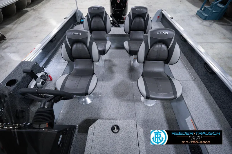 Slide: The Image of 2026 Lund 1800 Explorer SS boat interior with four gray seats and steering console. - 22