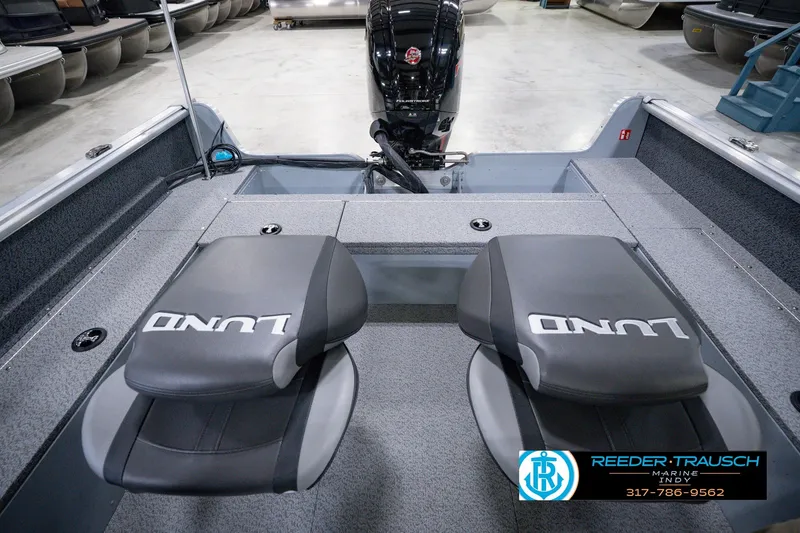 Slide: The Image of 2026 Lund 1800 Explorer SS boat interior with dual seats and motor, displayed at Reeder-Trausch Marine. - 25