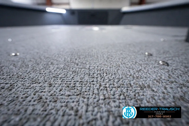 Slide: The Image of Carpeted deck of 2026 Lund 1800 Explorer SS boat, close-up view. - 49