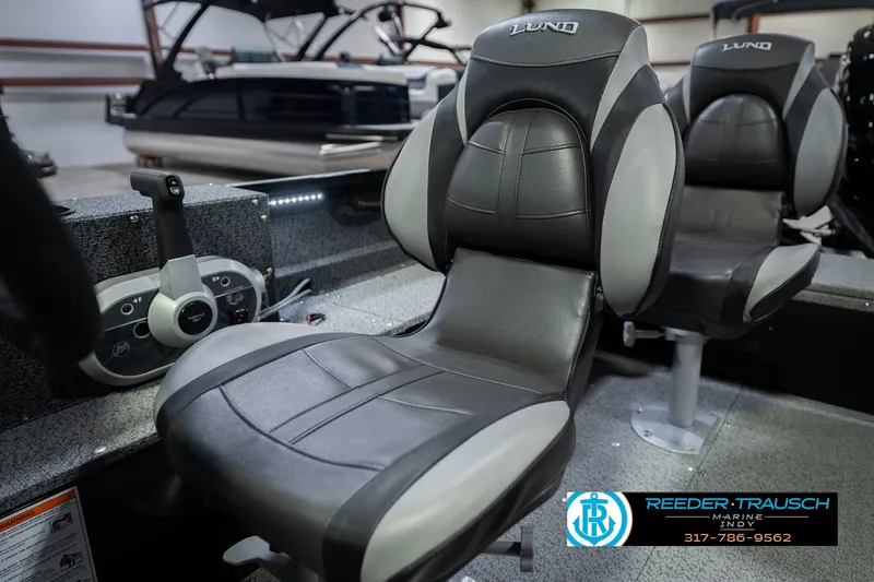 Slide: The Image of 2026 Lund 1800 Explorer SS boat interior with comfortable seating and control panel. - 65