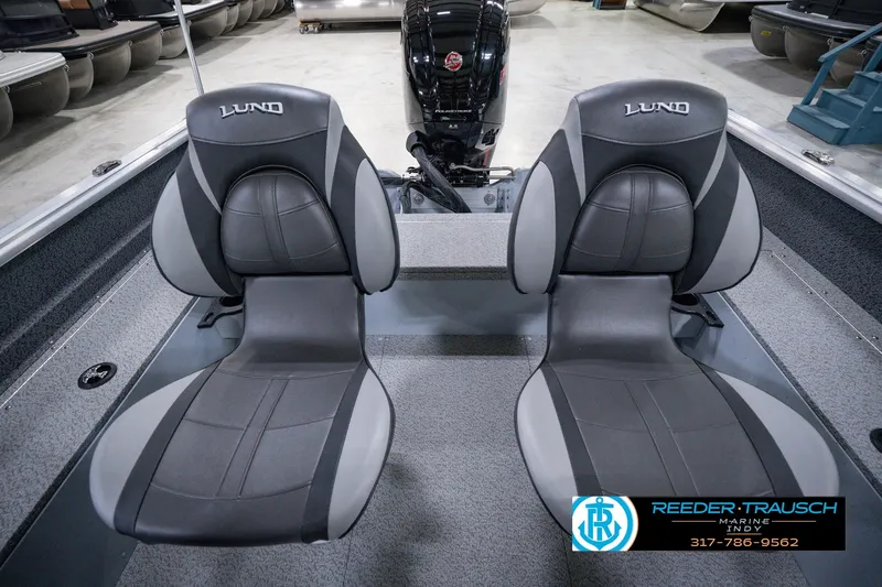 Slide: The Image of 2026 Lund 1800 Explorer SS boat interior with two gray seats and motor. - 24