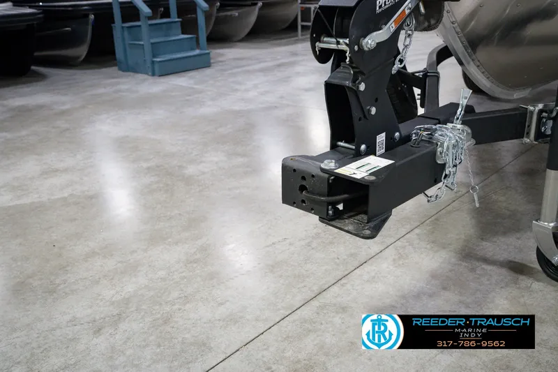 Slide: The Image of Trailer hitch of a 2026 Lund 1800 Explorer SS boat in a showroom. - 58