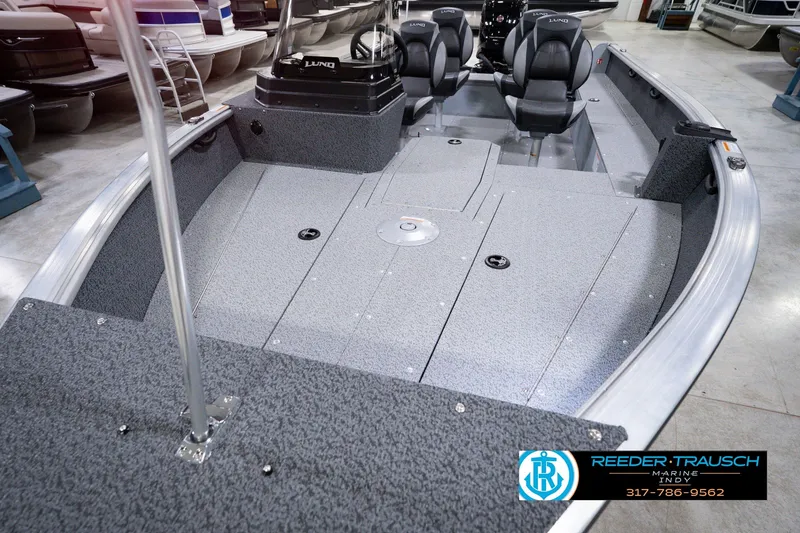 Slide: The Image of 2026 Lund 1800 Explorer SS boat interior with seating and console, displayed at Reeder-Trausch Marine. - 12