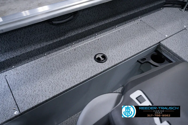 Slide: The Image of 2026 Lund 1800 Explorer SS boat interior with storage compartment and cup holder. - 28