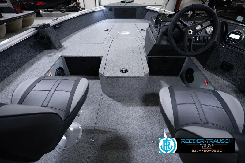 Slide: The Image of 2026 Lund 1800 Explorer SS boat interior with dual seats and steering console. - 18