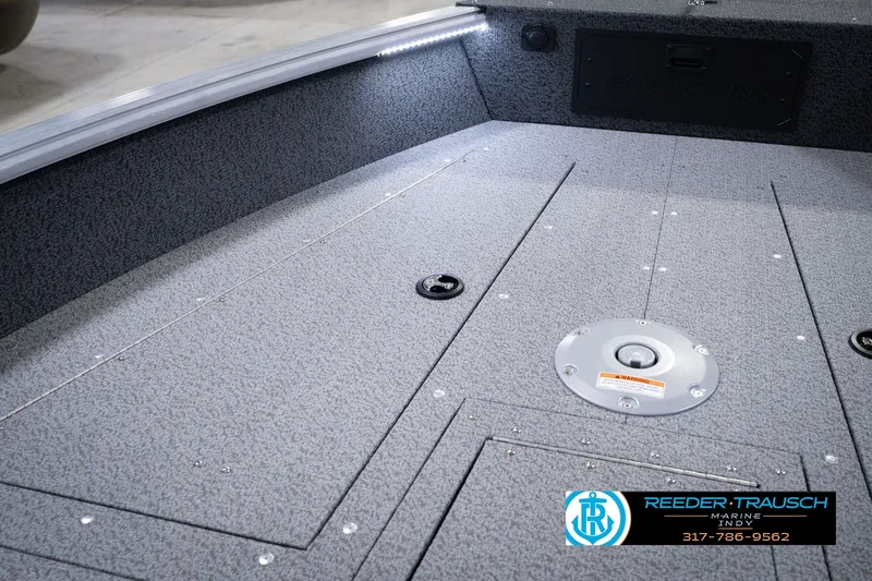 Slide: The Image of 2026 Lund 1800 Explorer SS boat interior with textured flooring and storage compartments. - 33
