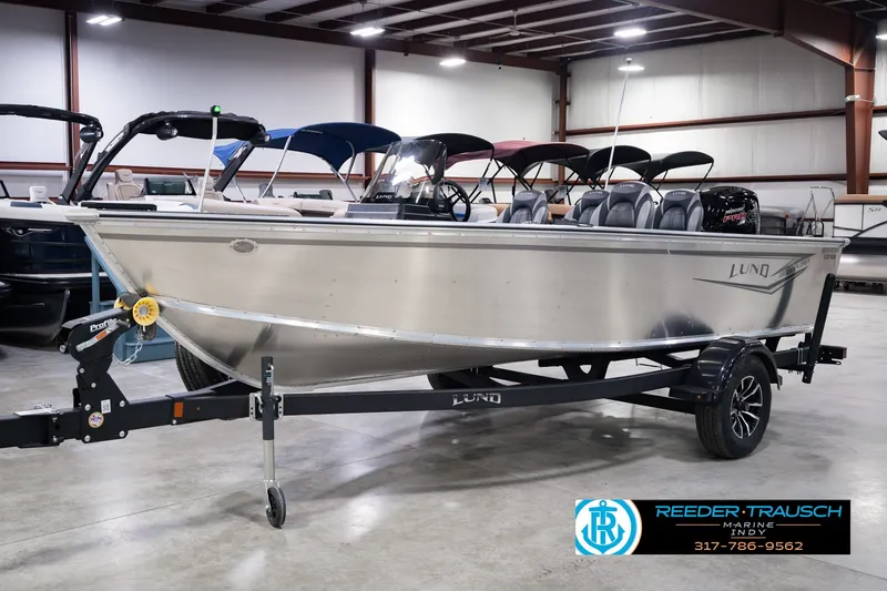 Slide: The Image of 2026 Lund 1800 Explorer SS boat on trailer in showroom. - 1