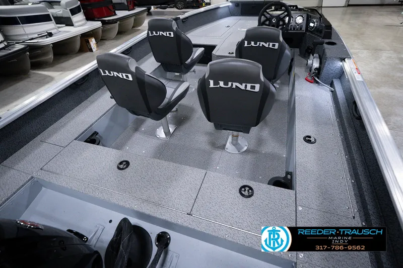 Slide: The Image of 2026 Lund 1800 Explorer SS boat interior with four seats and steering console. - 14