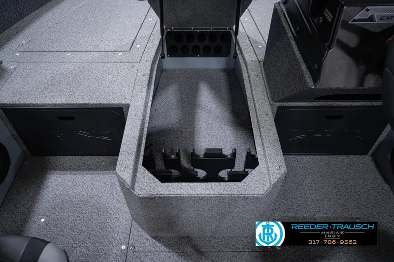 Slide: The Image of 2026 Lund 1800 Explorer SS boat interior with storage compartments and rod holders. - 32