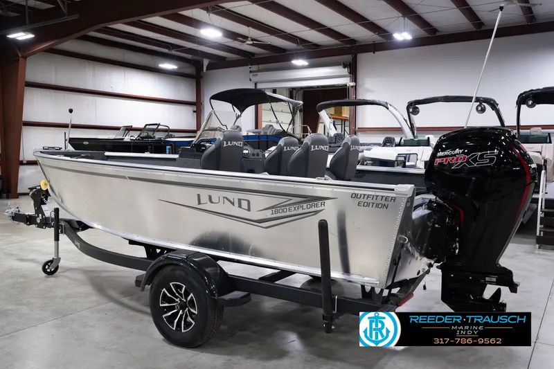 Slide: The Image of 2026 Lund 1800 Explorer SS boat in showroom, featuring Mercury Pro XS engine. - 9