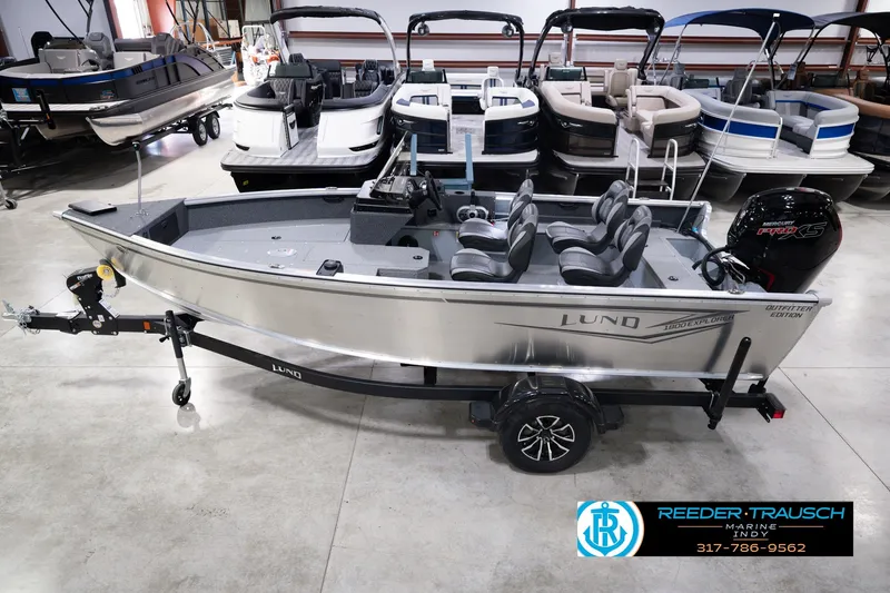The Image of 2026 Lund 1800 Explorer SS boat in showroom, featuring sleek design and modern seating. - 0