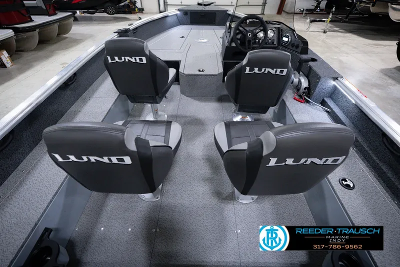 Slide: The Image of 2026 Lund 1800 Explorer SS boat interior with four seats and steering console. - 17