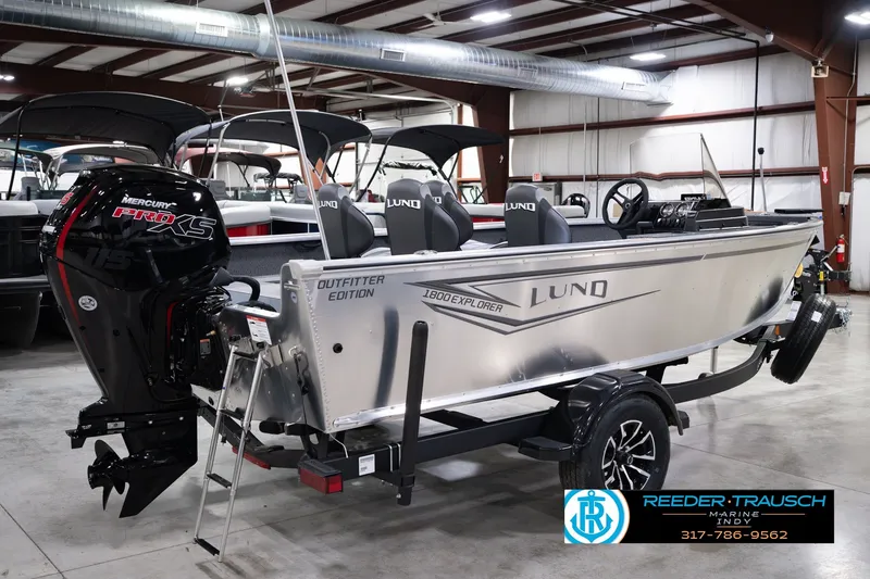 Slide: The Image of 2026 Lund 1800 Explorer SS boat in showroom, featuring Mercury Pro XS engine. - 6