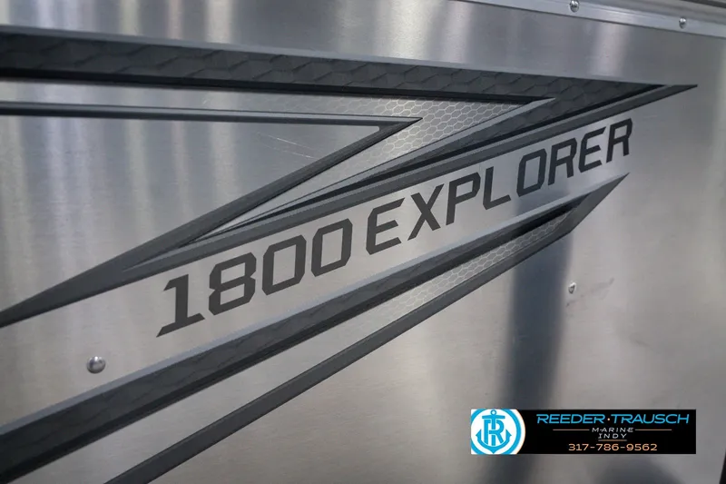 Slide: The Image of 2026 Lund 1800 Explorer SS boat logo on metallic surface. - 60