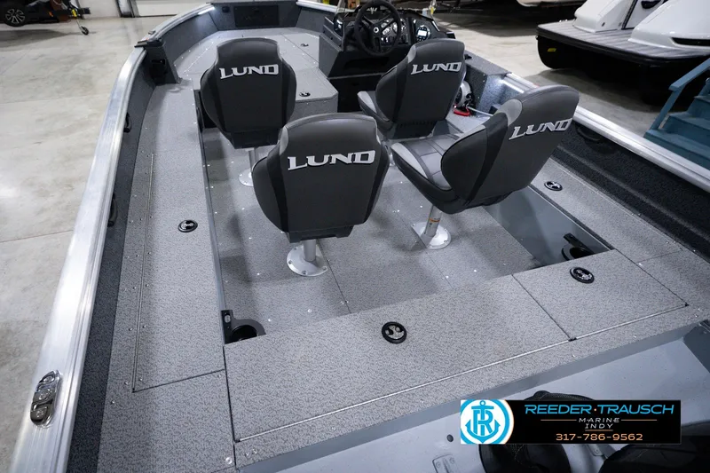 Slide: The Image of 2026 Lund 1800 Explorer SS boat interior with three seats and steering console. - 16