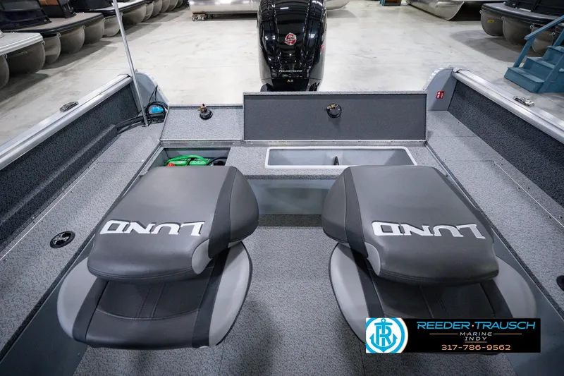 Slide: The Image of 2026 Lund 1800 Explorer SS boat interior with two seats and storage compartment. - 26
