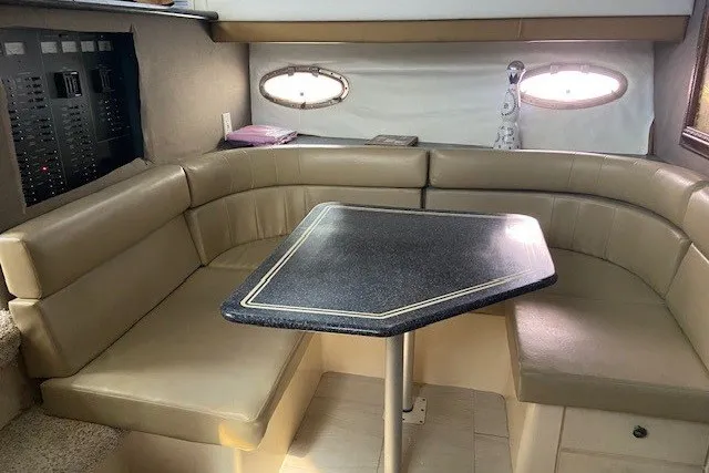 Slide: The Image of Interior of 2000 Carver 406 Aft Cabin Motor Yacht with beige seating and table. - 24