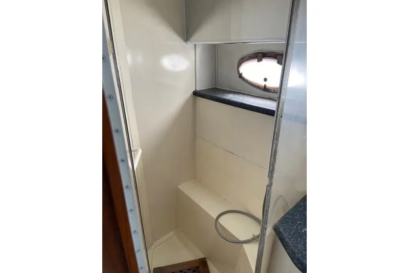 Slide: The Image of Interior of 2000 Carver 406 Aft Cabin Motor Yacht bathroom with porthole window. - 33
