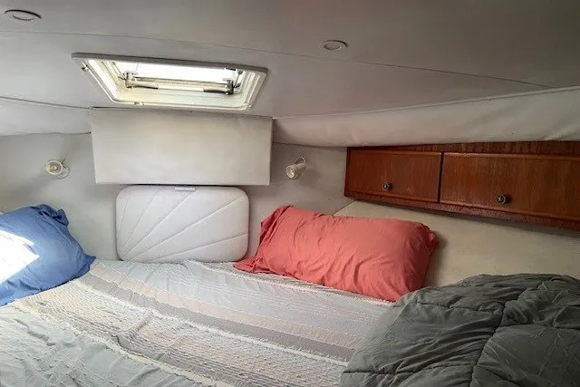 Slide: The Image of Cozy cabin interior of 2000 Carver 406 Aft Cabin Motor Yacht with bedding and storage. - 29