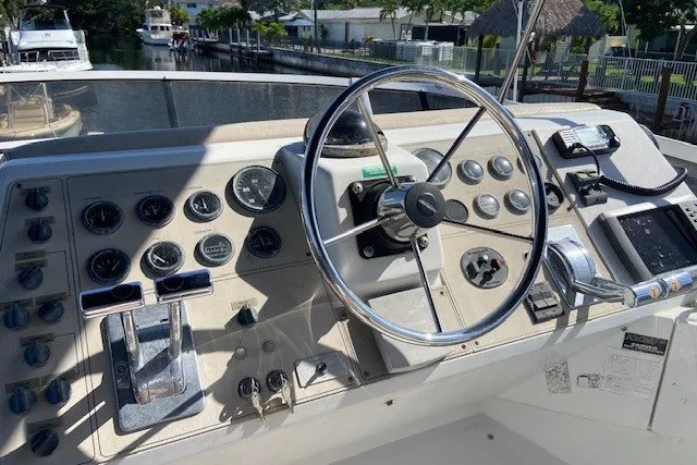 Slide: The Image of Control panel of a 2000 Carver 406 Aft Cabin Motor Yacht with steering wheel and gauges. - 14